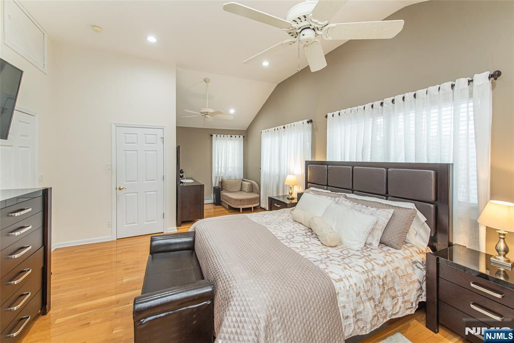 73 Grove Street Clifton, NJ 07013 - Photo 42 of 49 a bedroom with a bed and a flat tv screen on dresser