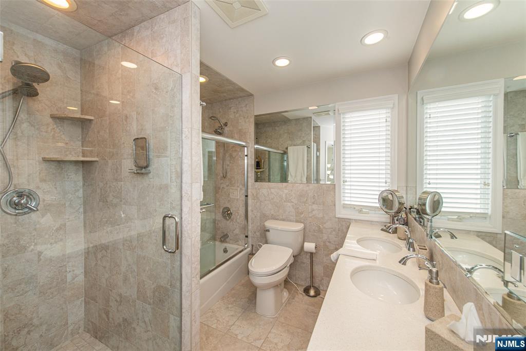73 Grove Street Clifton, NJ 07013 - Photo 44 of 49 a spacious bathroom with a bathtub shower sink mirror and toilet