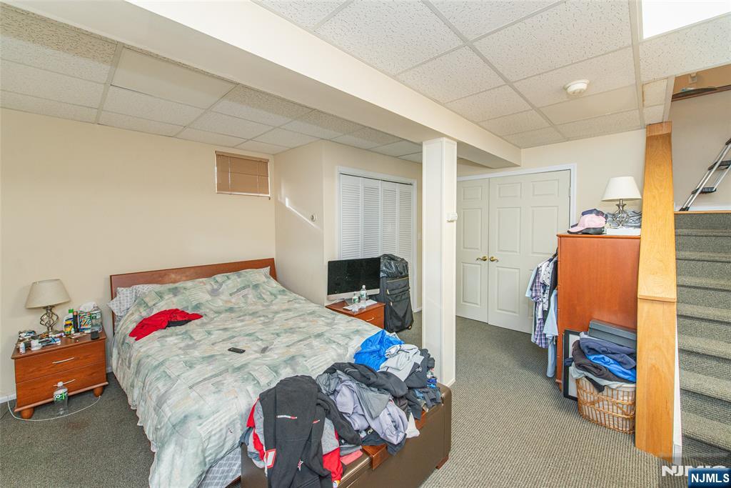 73 Grove Street Clifton, NJ 07013 - Photo 46 of 49 a bedroom with a bed and a tv