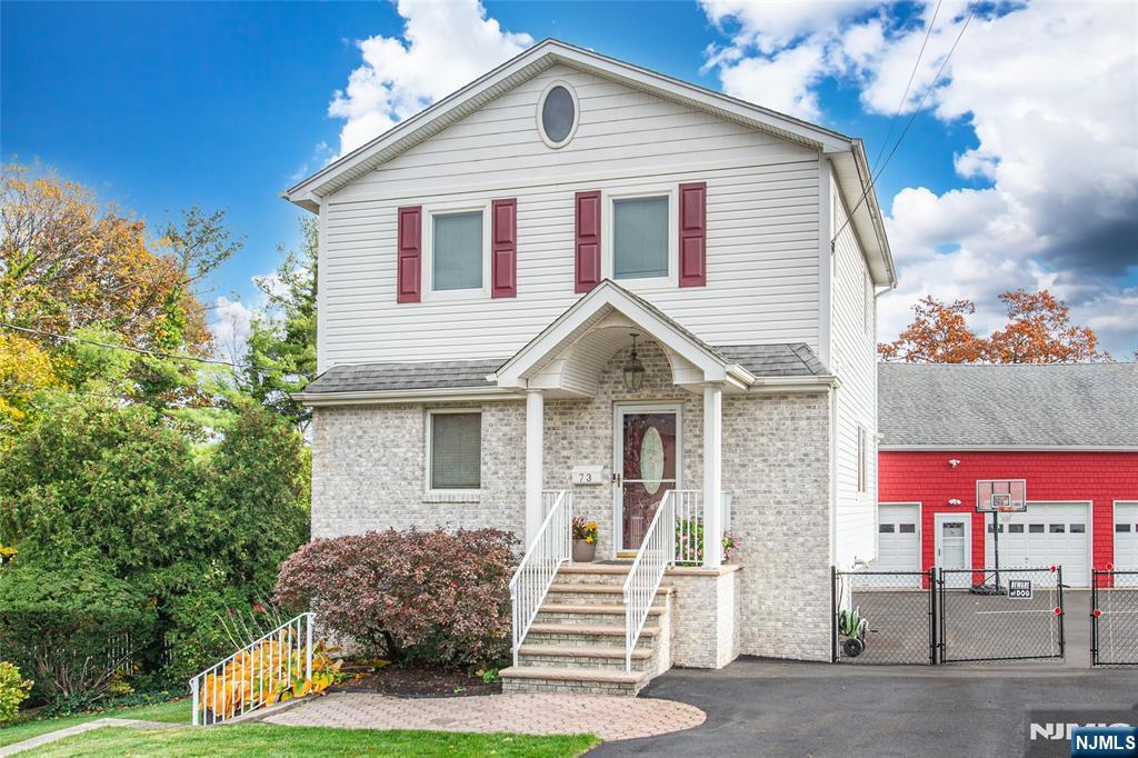 73 Grove Street Clifton, NJ 07013 - Photo 6 of 49 a front view of a house with a yard
