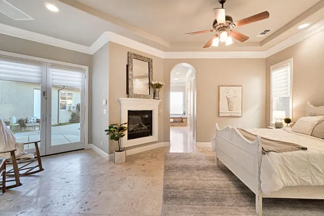 a spacious bathroom with a granite countertop double vanity sink a mirror and a shower