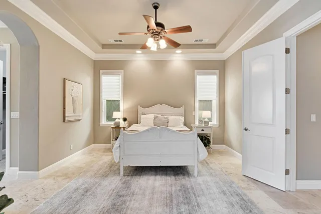 a view of a lake with table and chairs next to a yard