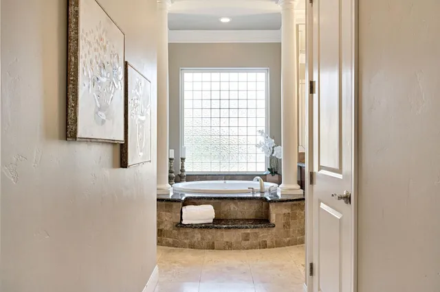 a view of a patio with a table and chairs and potted plants