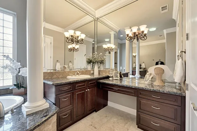 a view of a white house next to a road and trees