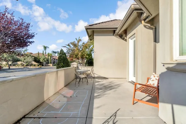 an aerial view of a house with a yard and flowers