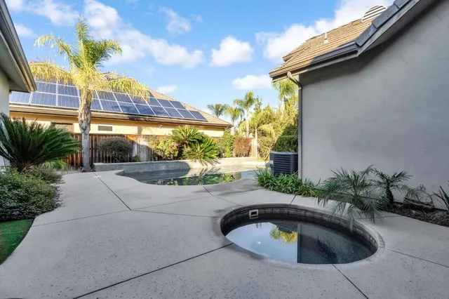 a aerial view of a house with swimming pool and sitting area