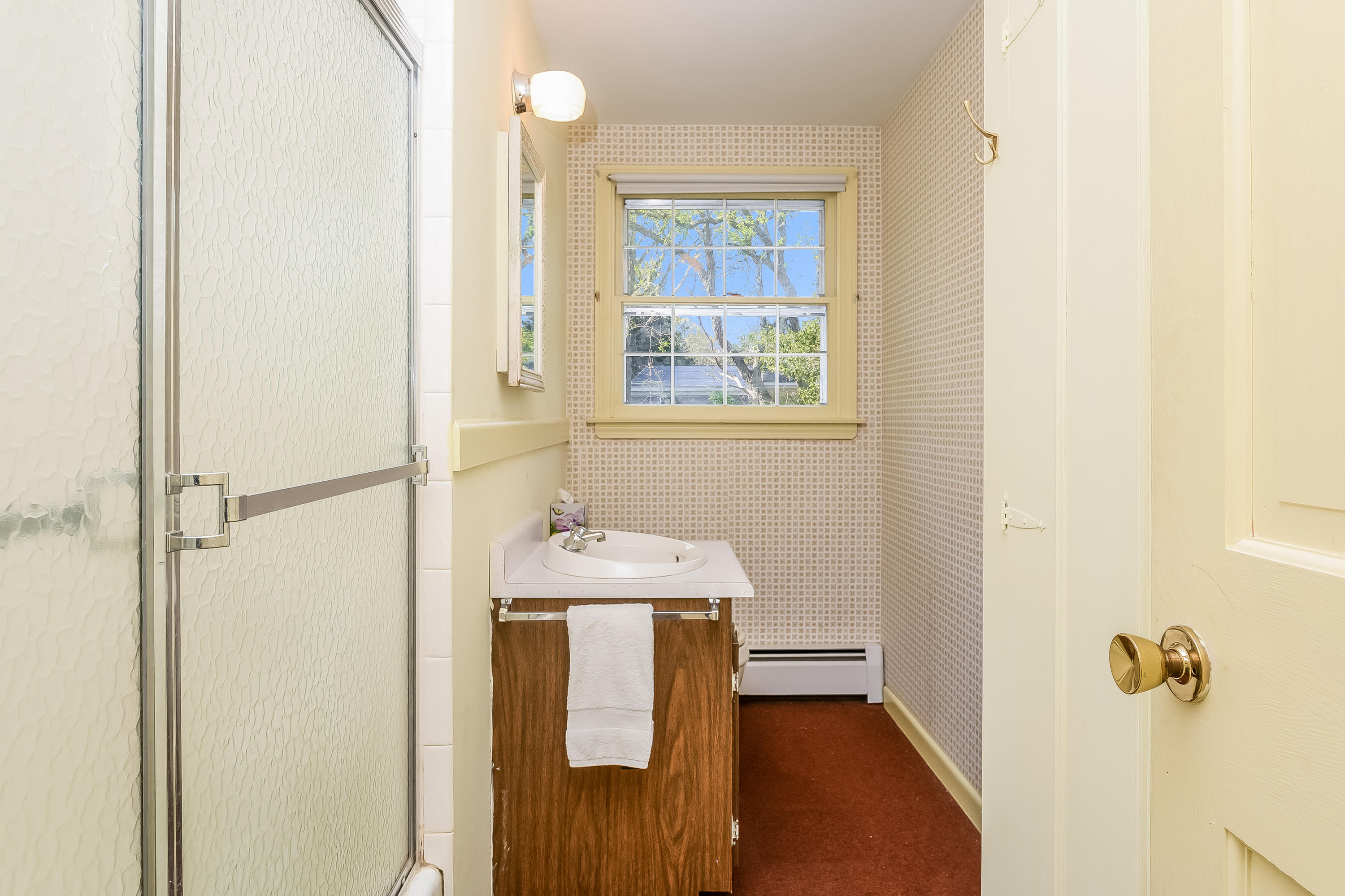 65 Chase Road Falmouth, MA 02540 - Photo 12 of 28 a bathroom with a sink a mirror and a shower