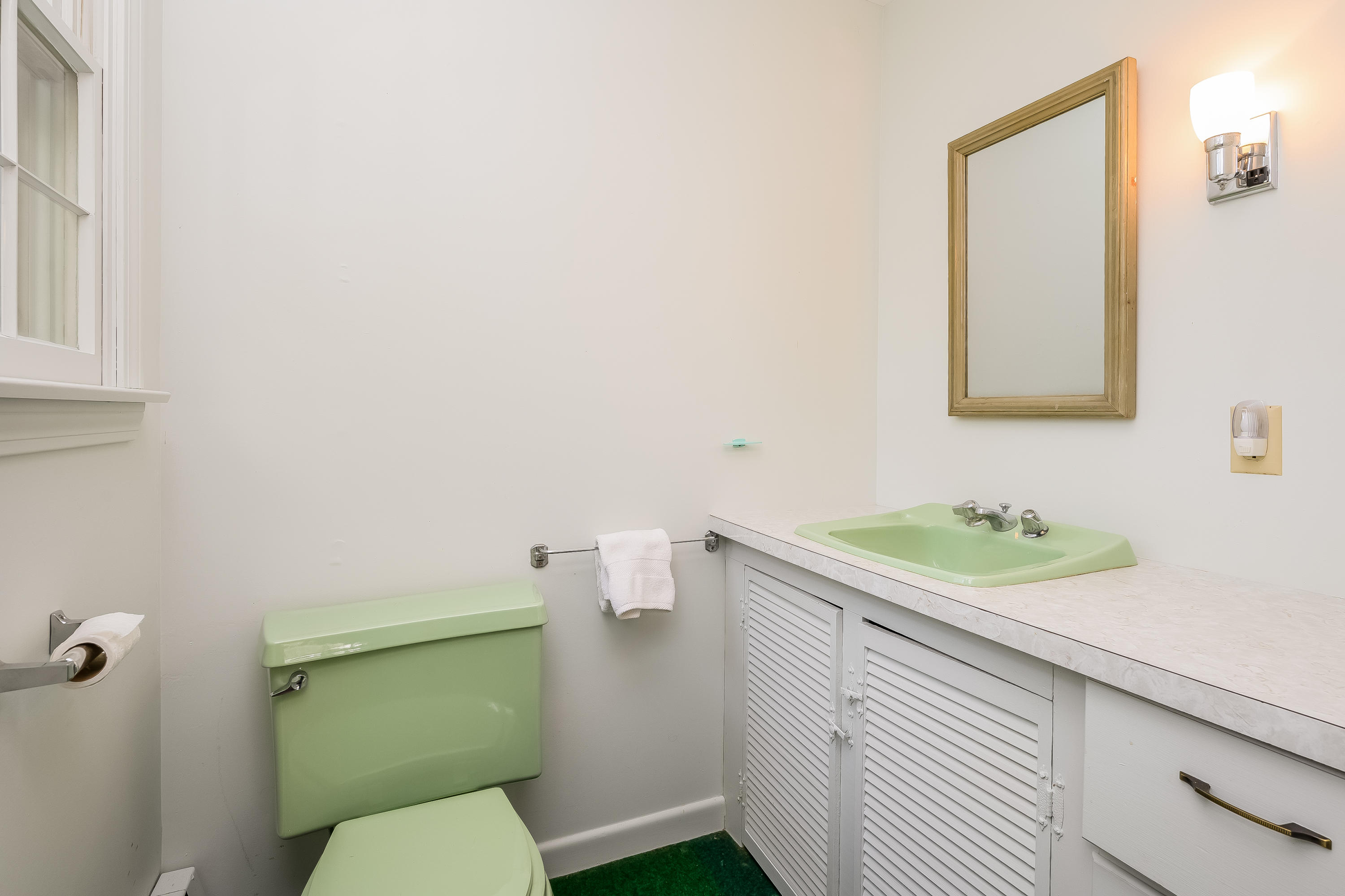 65 Chase Road Falmouth, MA 02540 - Photo 15 of 28 a bathroom with a toilet sink and mirror