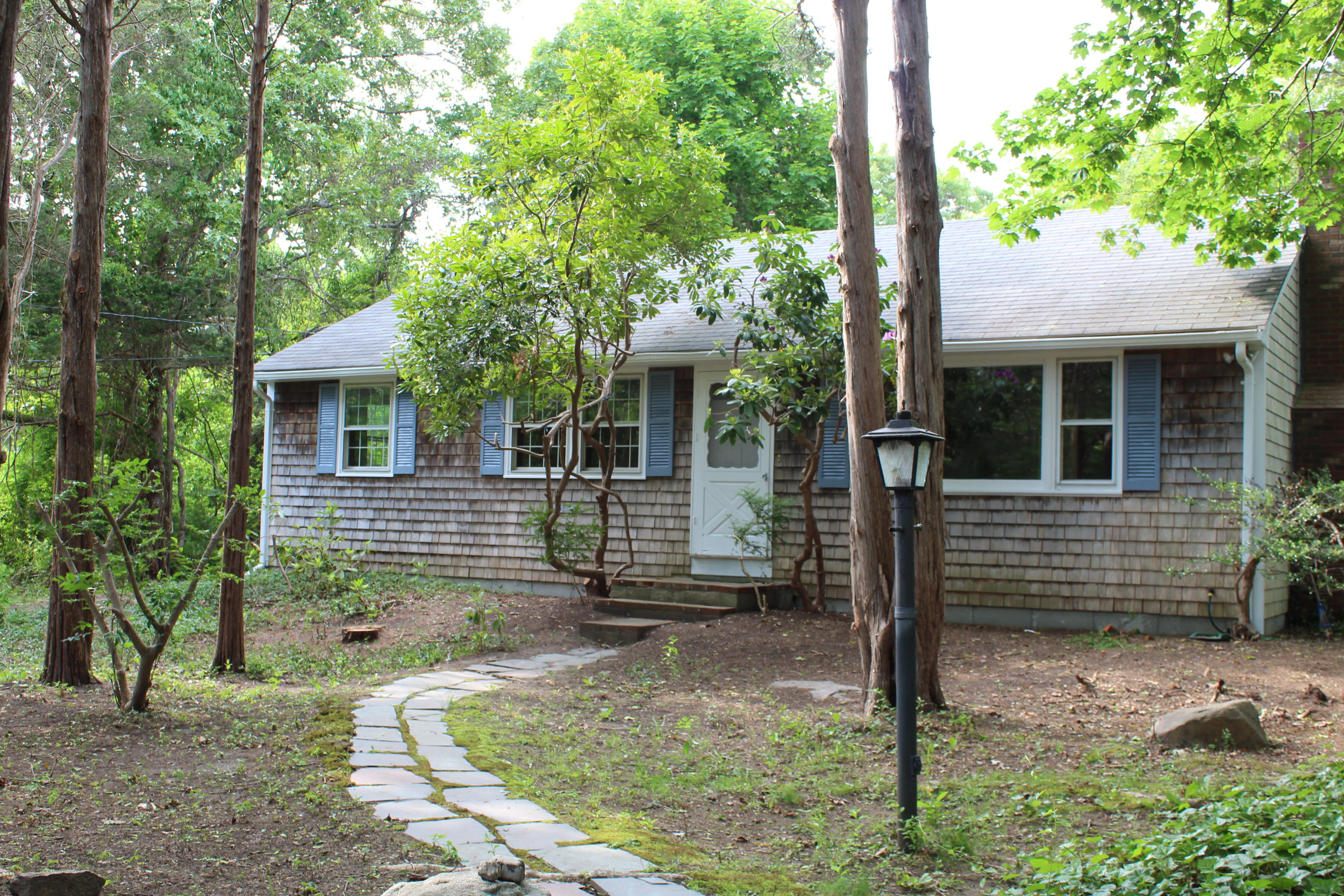 65 Chase Road Falmouth, MA 02540 - Photo 2 of 28 a front view of a house with garden