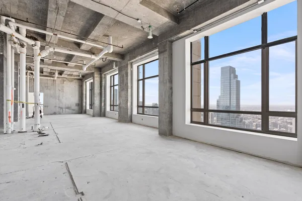 a view of an empty room with a fireplace and a window