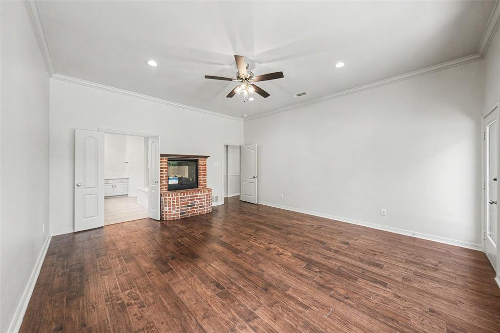 1200 Mount Gilead Road Keller, TX 76262 - Photo 23 of 38 an empty room with wooden floor ceiling fan and windows