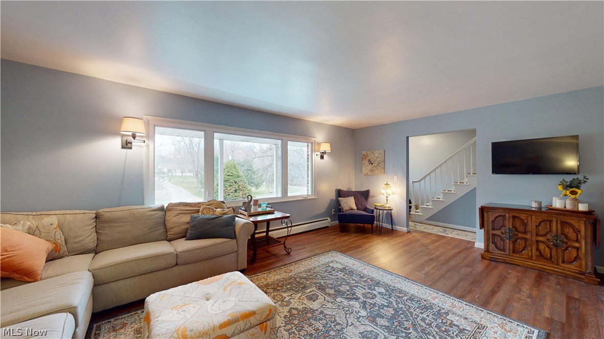 12326 Huntoon Road Painesville, OH 44077 - Photo 14 of 38 Living room featuring baseboard heating and dark hardwood / wood-style floors