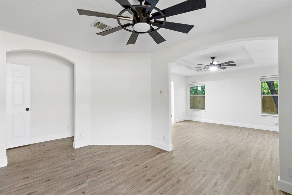 617 Barbara Way Bastrop, TX 78602 - Photo 8 of 20 Elegant arches and contemporary flooring define this versatile interior space, illuminated by recessed lighting.
