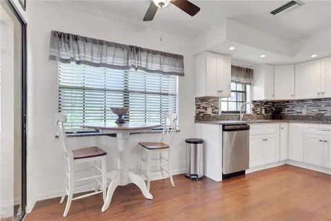 a kitchen with stainless steel appliances granite countertop a stove a sink dishwasher and a refrigerator