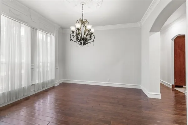 a view of a room with wooden floor and windows