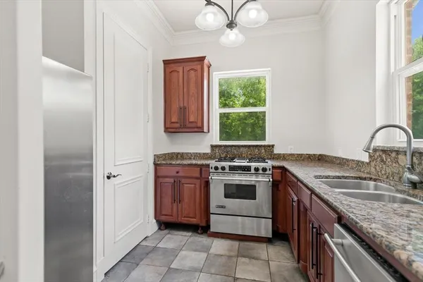 a utility room with granite countertop cabinets washer and dryer