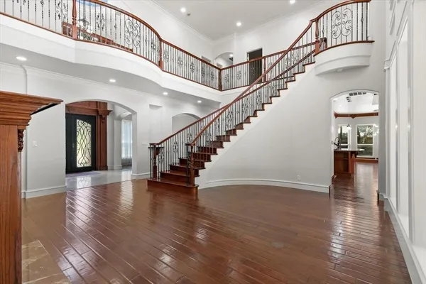 a view of a livingroom with wooden floor and a fireplace