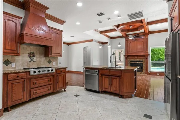 a kitchen with kitchen island a sink stove and refrigerator