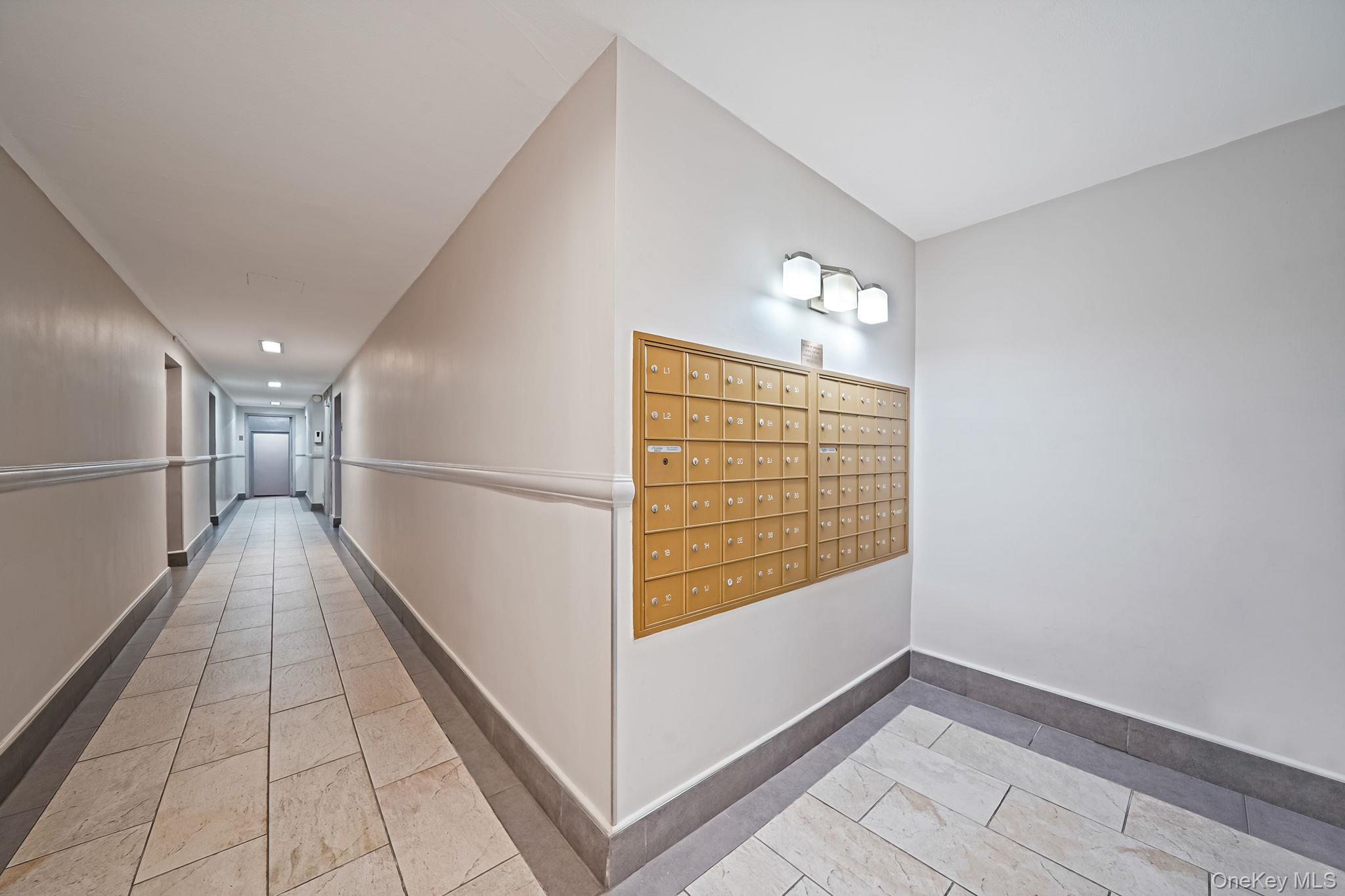 67-50 Thornton Place, Unit 4U Queens, NY 11375 - Photo 17 of 19 Hall featuring mail area and light tile patterned flooring