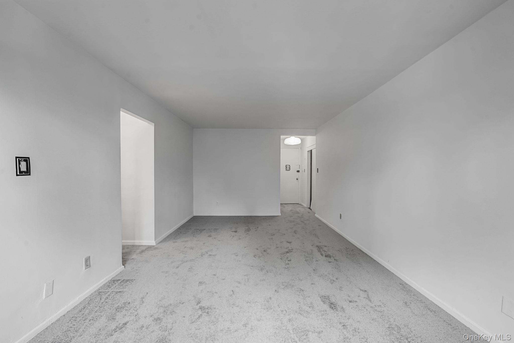 67-50 Thornton Place, Unit 4U Queens, NY 11375 - Photo 8 of 19 Empty room with carpet and baseboards