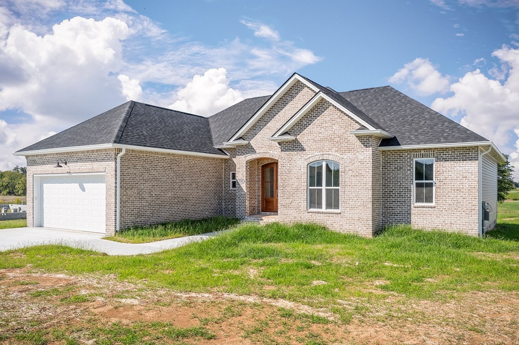 136 Dairy Barn Road Sparta, TN 38583 - Photo 2 of 58 a front view of a house with a garden