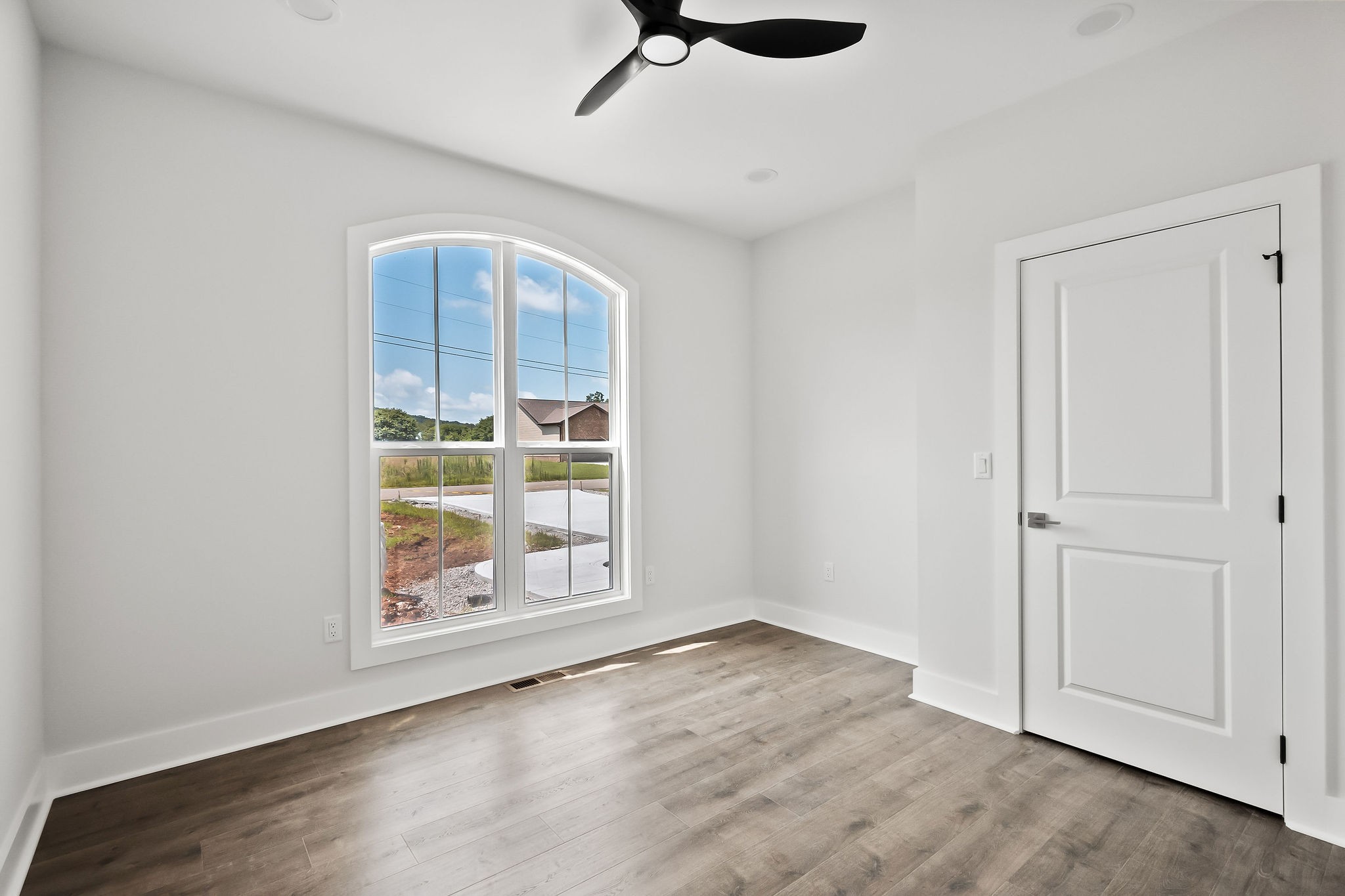 136 Dairy Barn Road Sparta, TN 38583 - Photo 41 of 58 an empty room with wooden floor cabinet and windows