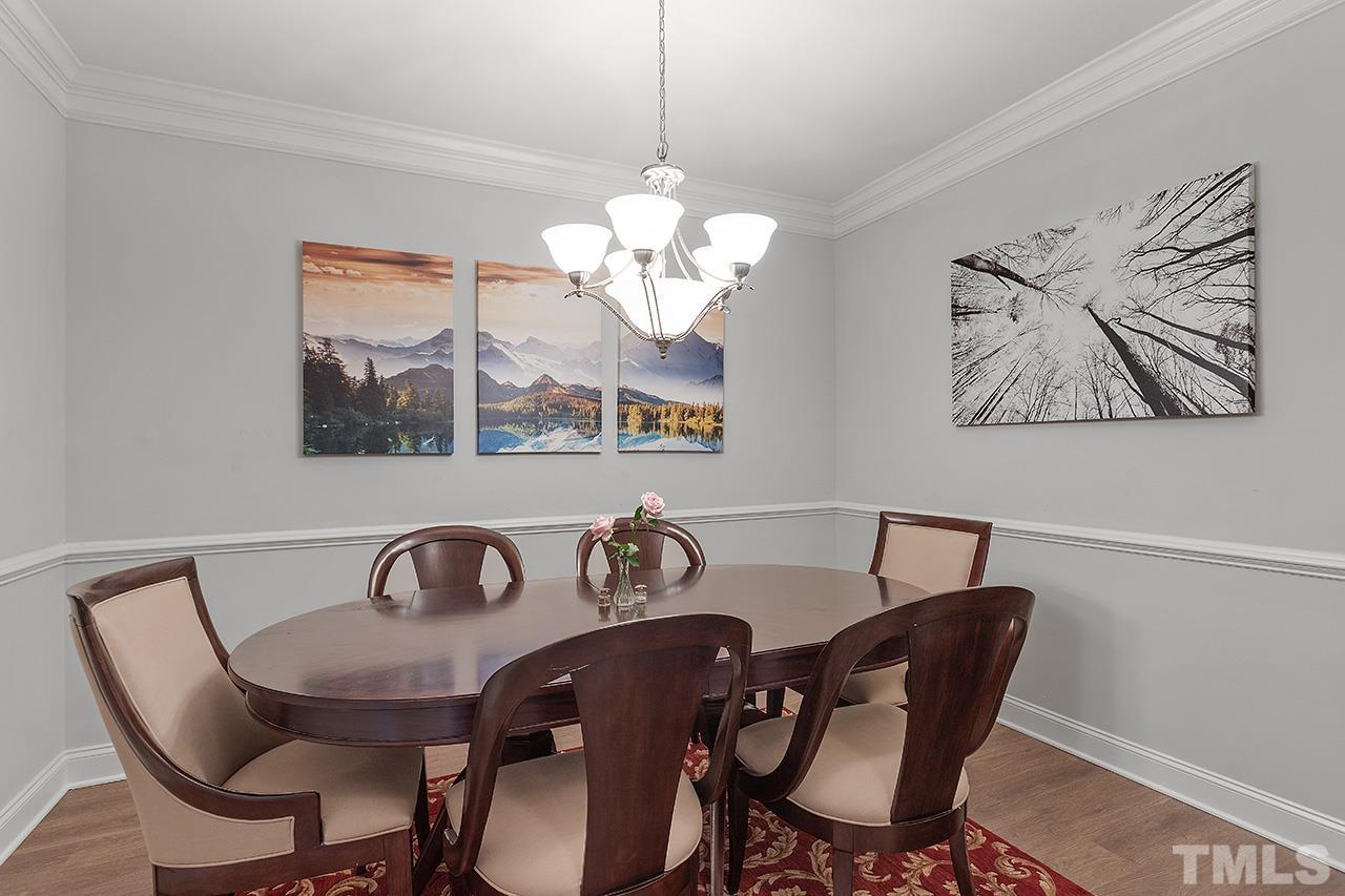 10421 Rosegate Court, Unit 5 Raleigh, NC 27617 - Photo 12 of 35 a view of a dining room with furniture and chandelier