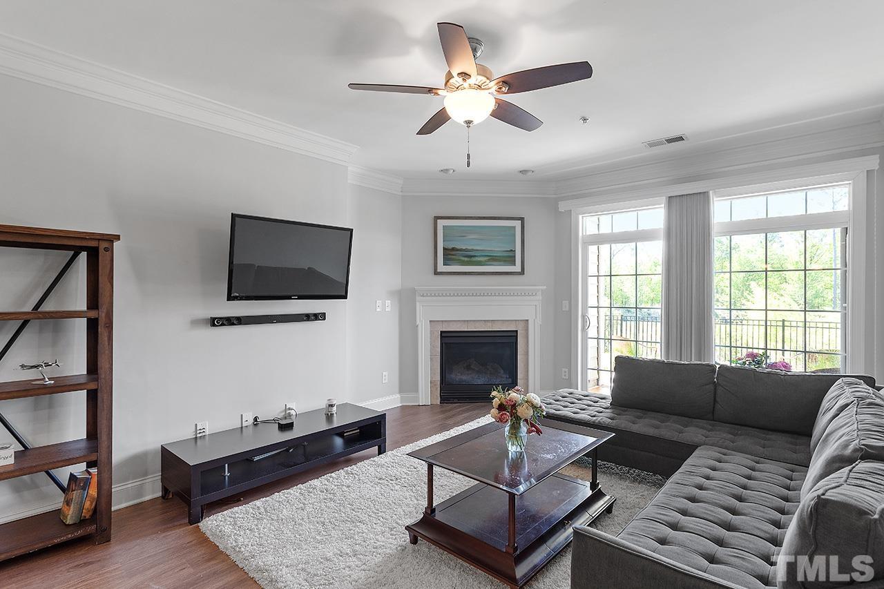 10421 Rosegate Court, Unit 5 Raleigh, NC 27617 - Photo 17 of 35 a living room with furniture a flat screen tv and a fireplace