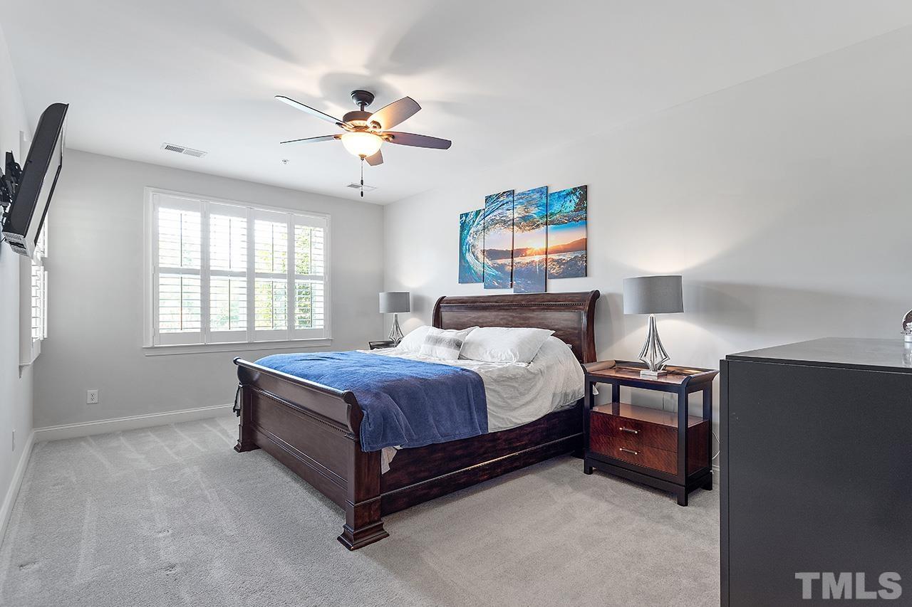 10421 Rosegate Court, Unit 5 Raleigh, NC 27617 - Photo 25 of 35 a bedroom with a bed dresser and a window