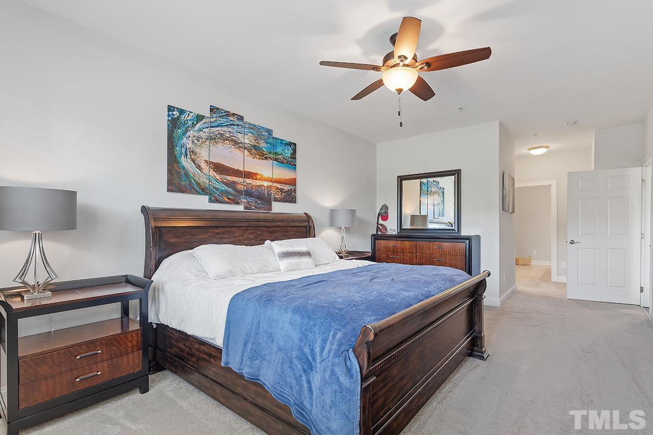 10421 Rosegate Court, Unit 5 Raleigh, NC 27617 - Photo 26 of 35 a bed room with a bed and a lamp