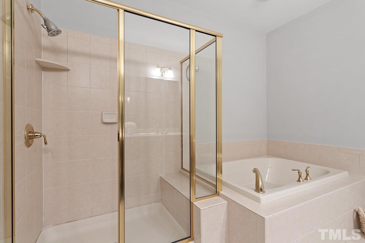 10421 Rosegate Court, Unit 5 Raleigh, NC 27617 - Photo 28 of 35 a bathroom with a tub and a shower