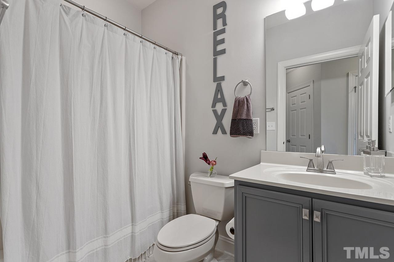 10421 Rosegate Court, Unit 5 Raleigh, NC 27617 - Photo 29 of 35 a bathroom with a toilet a sink and a mirror