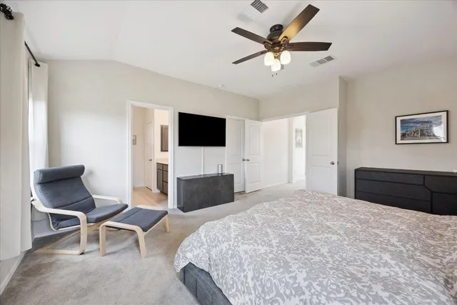 a bedroom with a bed and a chair