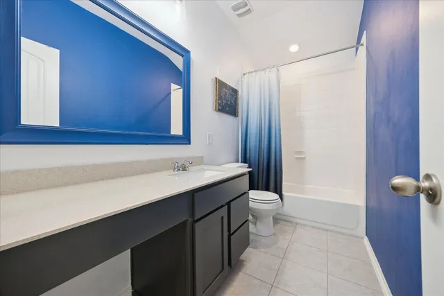 a bathroom with a double vanity sink toilet and shower