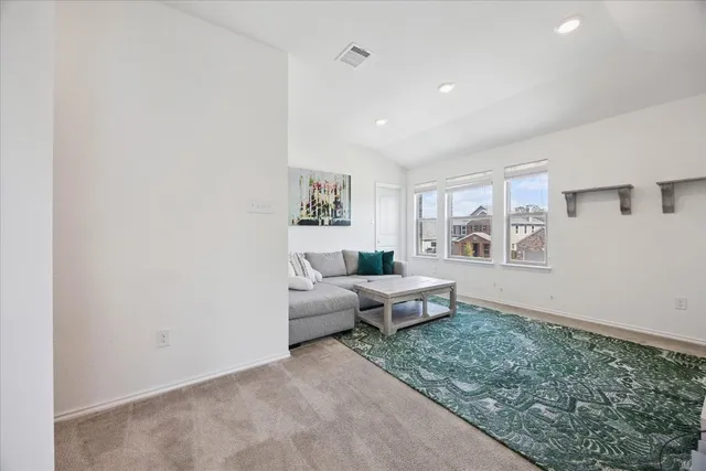 a living room with furniture and next to a window