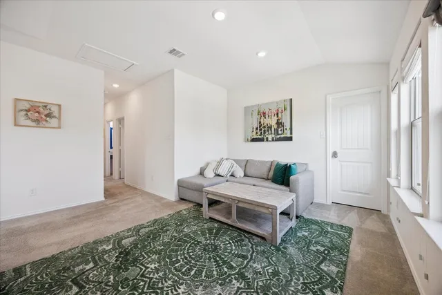 a living room with furniture and a rug
