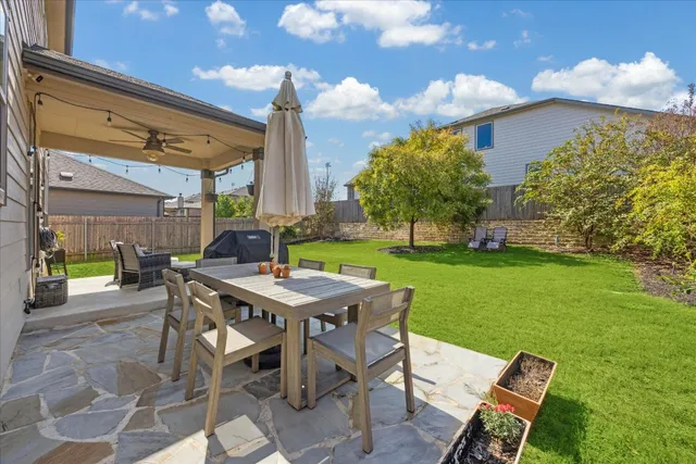 a view of a backyard with plants and patio