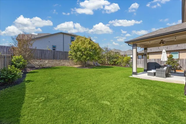 a view of a backyard with sitting area
