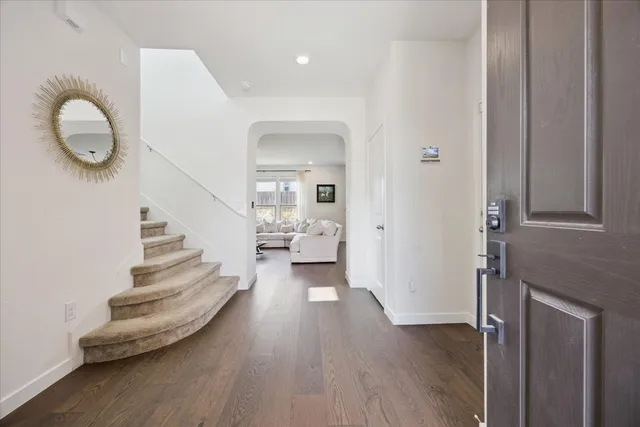a view of entryway and hall with wooden floor