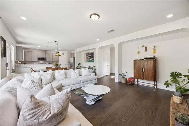 a living room with furniture and a dining table