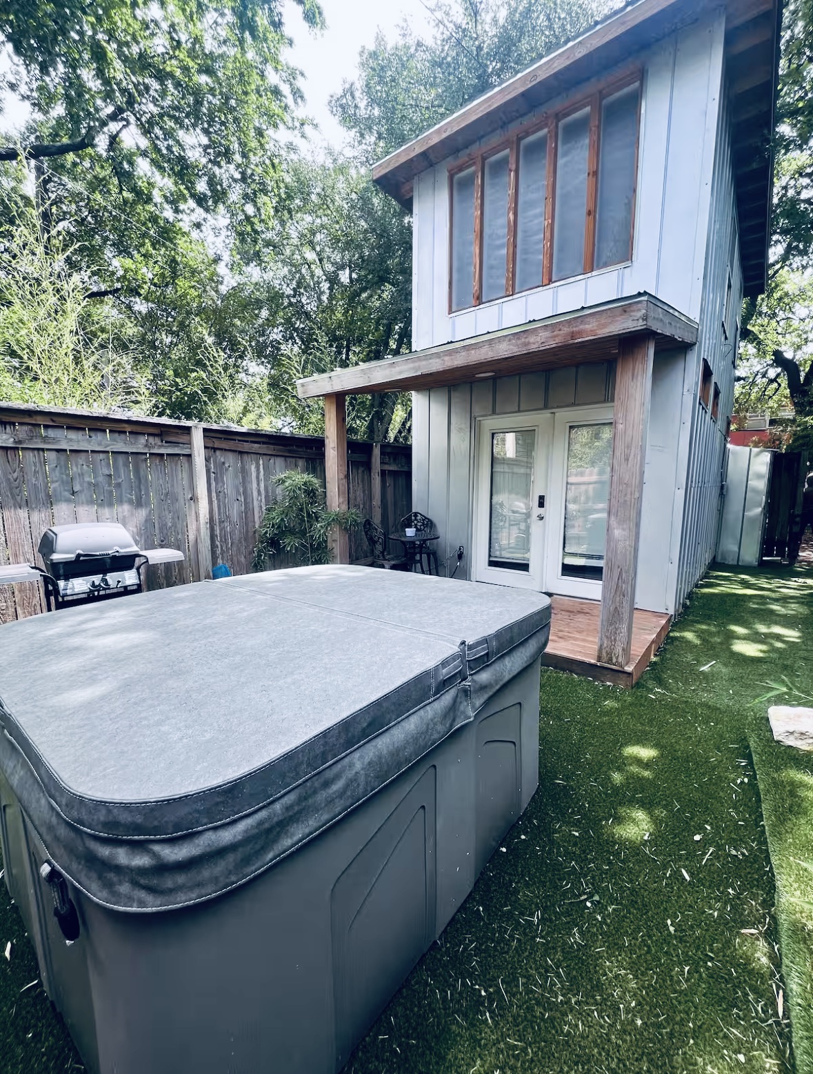 307 East 35th Street, Unit A Austin, TX 78705 - Photo 22 of 31 An inviting backyard oasis offers a private spa and a charming guest house with a covered patio.