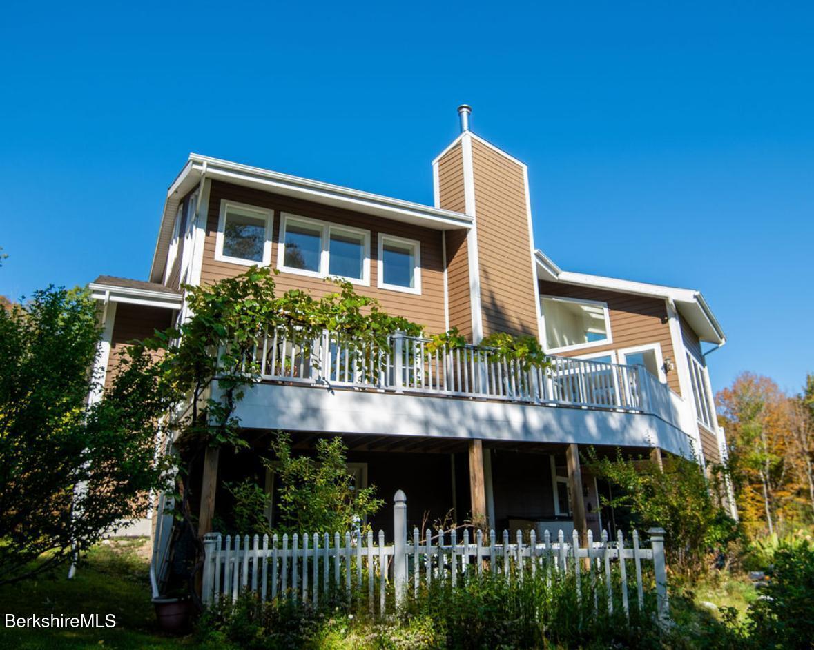 107 Wilderness Way Stephentown, NY 12169 - Photo 1 of 33 a front view of a house with a yard