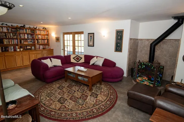 a living room with furniture a rug and a large window