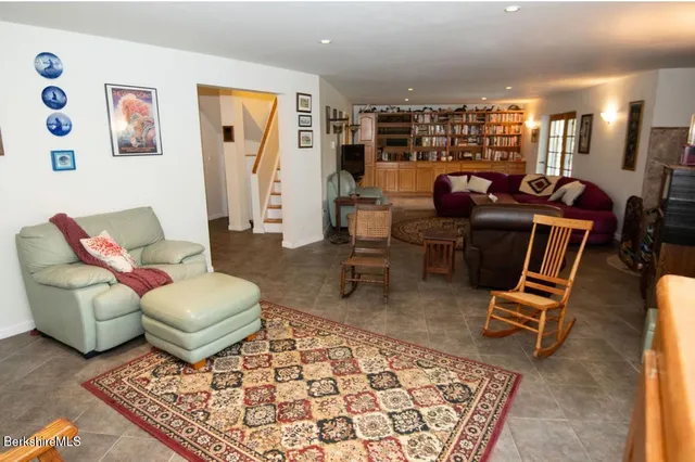 a living room with furniture a rug and a table