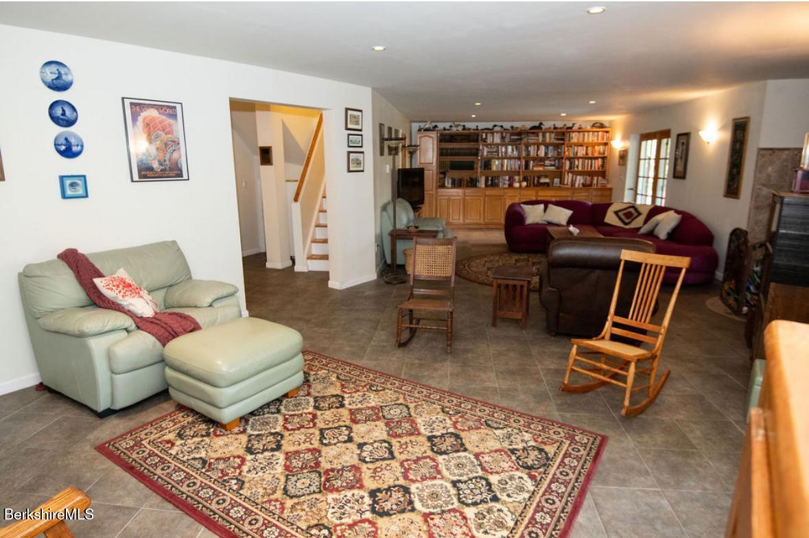 107 Wilderness Way Stephentown, NY 12169 - Photo 16 of 33 a living room with furniture a rug and a table