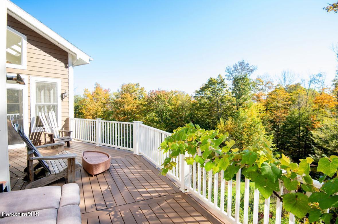 107 Wilderness Way Stephentown, NY 12169 - Photo 27 of 33 a view of a patio with table and chairs and potted plants with wooden floor and fence