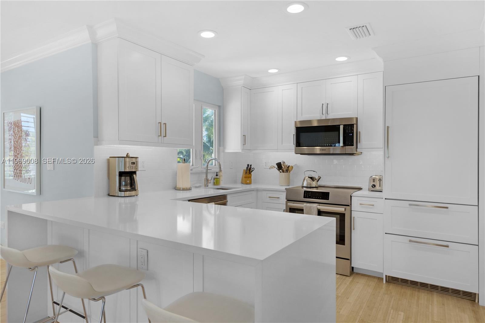 26 Marlin Lane, Unit B Key Largo, FL 33037 - Photo 3 of 16 a kitchen with a sink microwave and cabinets