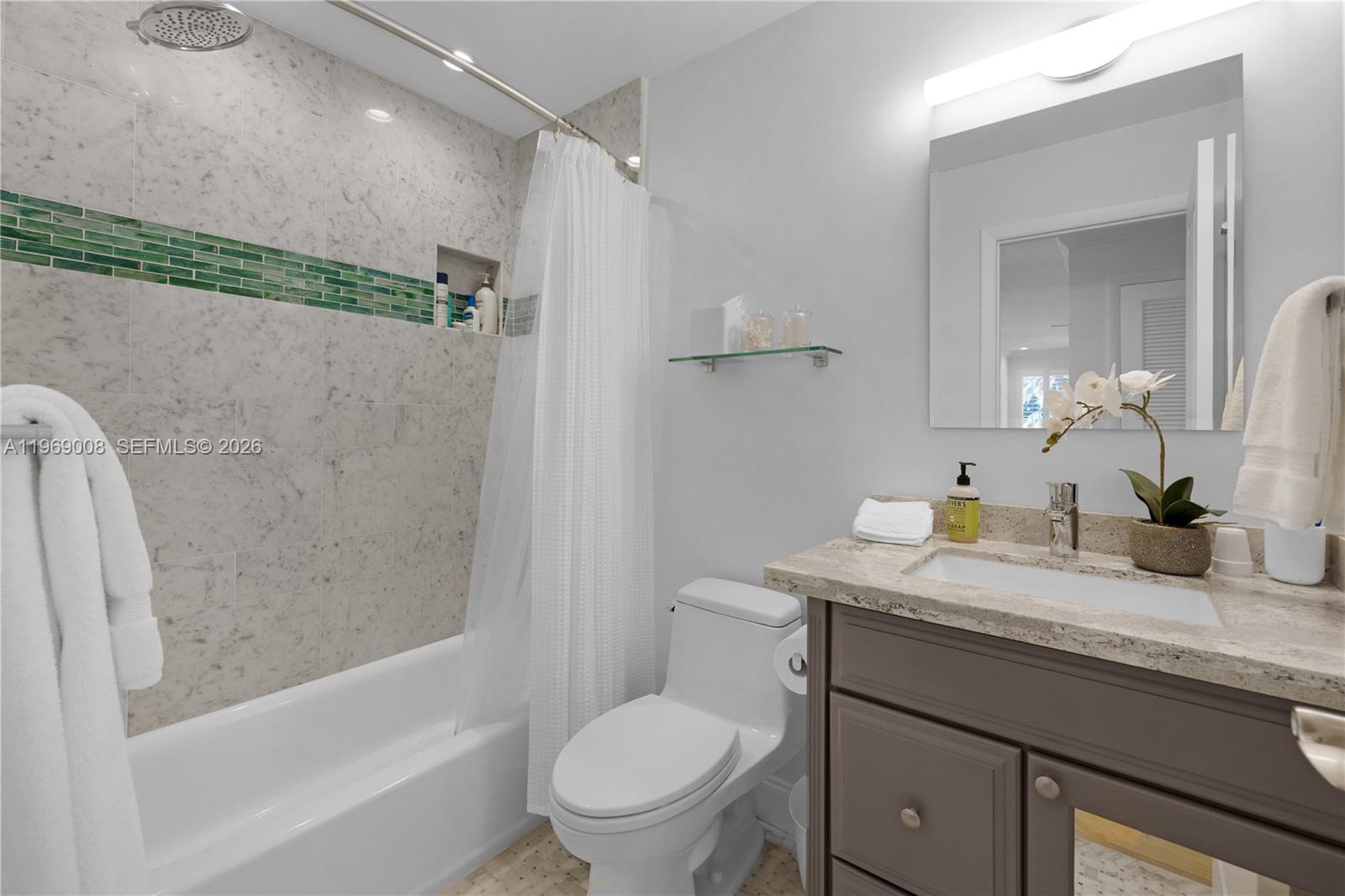 26 Marlin Lane, Unit B Key Largo, FL 33037 - Photo 10 of 16 a bathroom with a granite countertop sink a toilet and shower