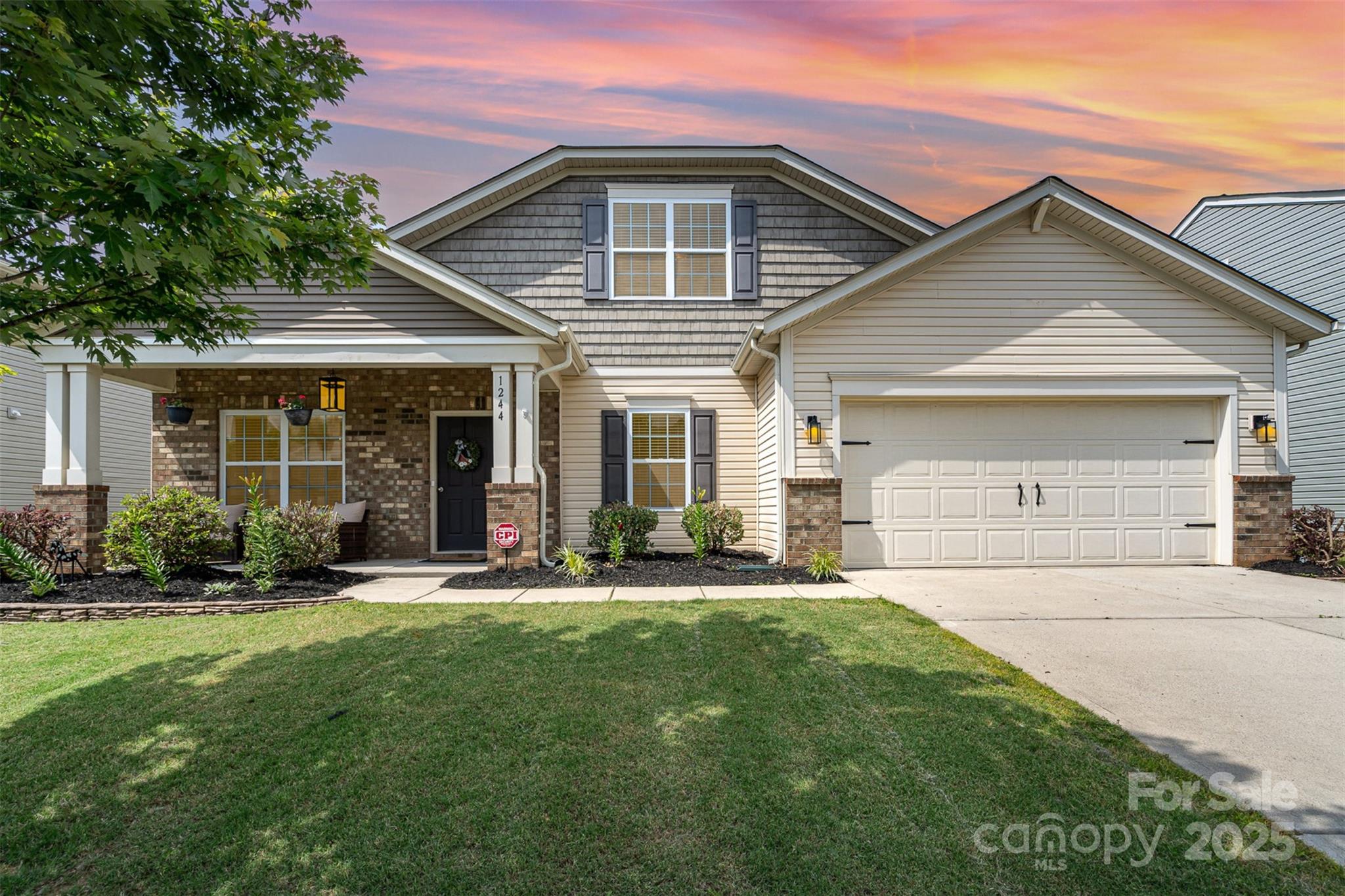 1244 Tranquil Falls Lane Matthews, NC 28104 - Photo 1 of 40 a front view of a house with a yard and trees
