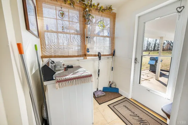 a balcony with wooden floor table and chairs